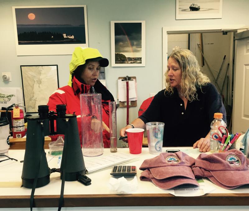 Rockport Harbormaster Abbie Leonard and assistant Eliza Massey measure more than 5 inches of rain that fell by 2 p.m. today, Sept. 30. (Photo by Lynda Clancy)