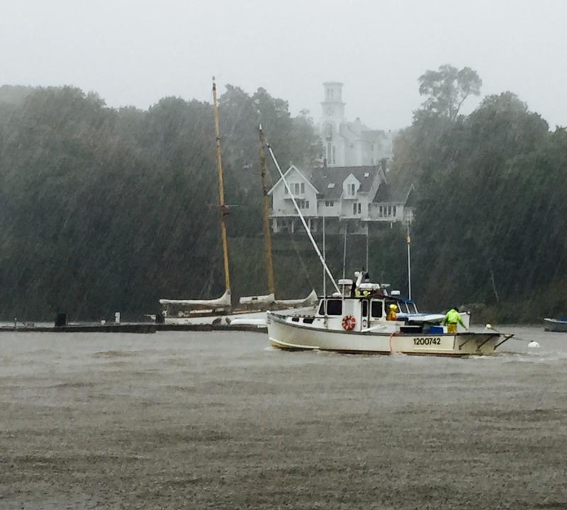 A lobster boat returns to Rockport Harbor in the pelting rain. (Photo by Lynda Clancy)