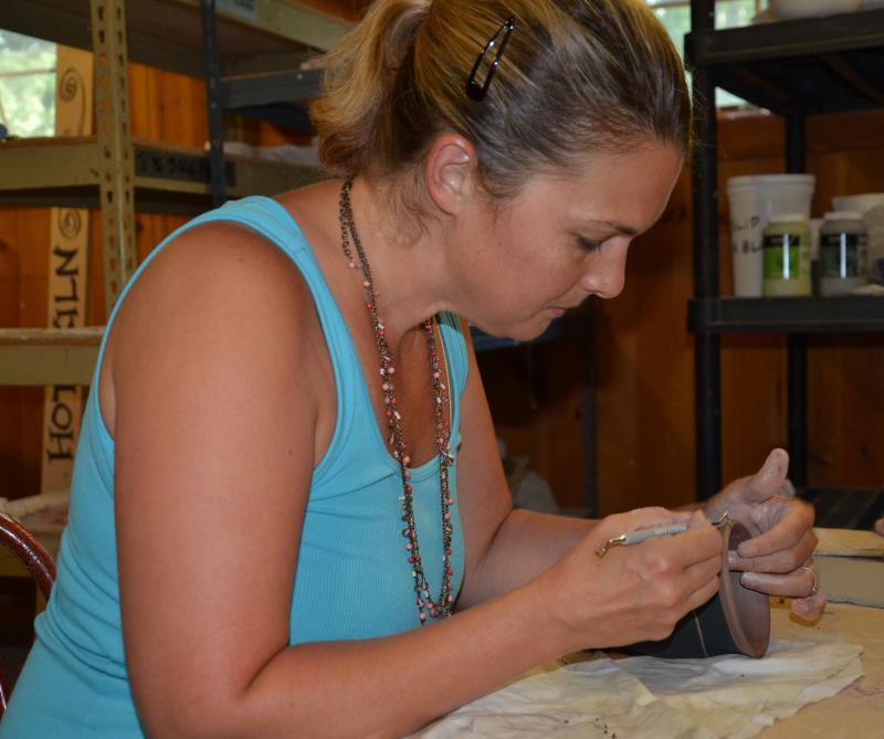 Courtney Lanphere puts the finish on her ceramic cup Hope Clay studio. (Photo by Lynda Clancy)