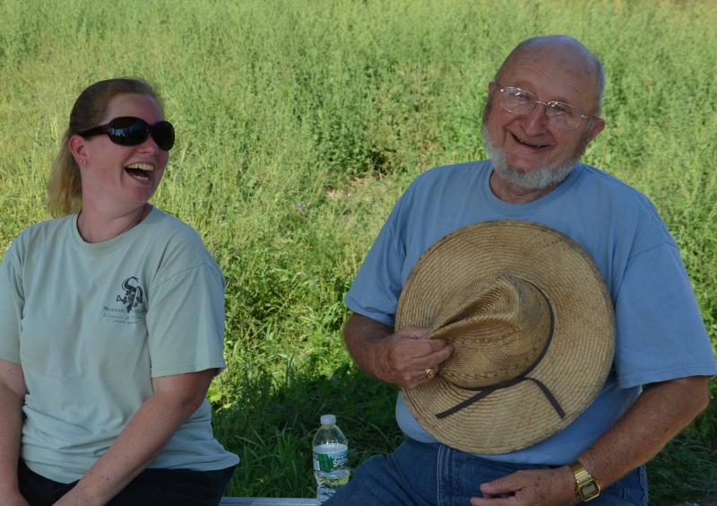 Hillary Savage Kuhl and her father, Don Oakes, tending the gate to the vineyard that grows in back of the farm. (Photo by Lynda Clancy)