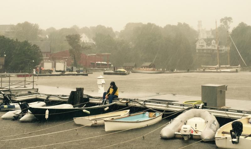 Boats are being baled nonstop as more than five inches of rain fell earlier on Sept. 30 in the Midcoast. In Rockport Harbor, assistant harbor master Eliza Massey has been pumping a series of dinghies at the dock. (Photo by Lynda Clancy)
