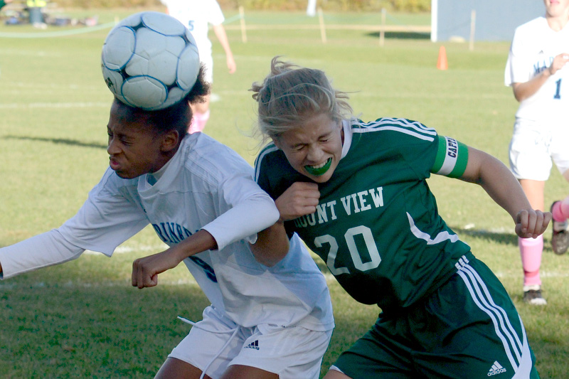 Oceanside’s Hope Butler, left, gets to the ball to put a head on it just ahead of Mount View’s Lilly Redwine. (Photo by Ron Hawkes)