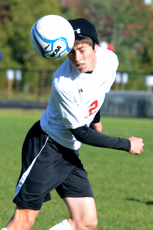 Camden Hills Andy Gross uses a header to get the ball headed back up the field for the Windjammers. (Photo by Ron Hawkes)