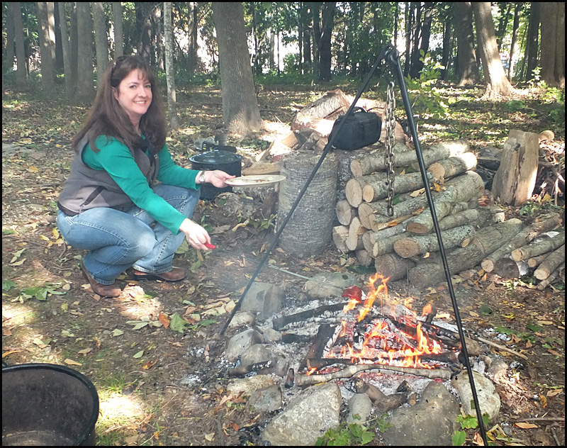 Heather Moran cooks maple marinated pepperoni on a stick over an open fire.