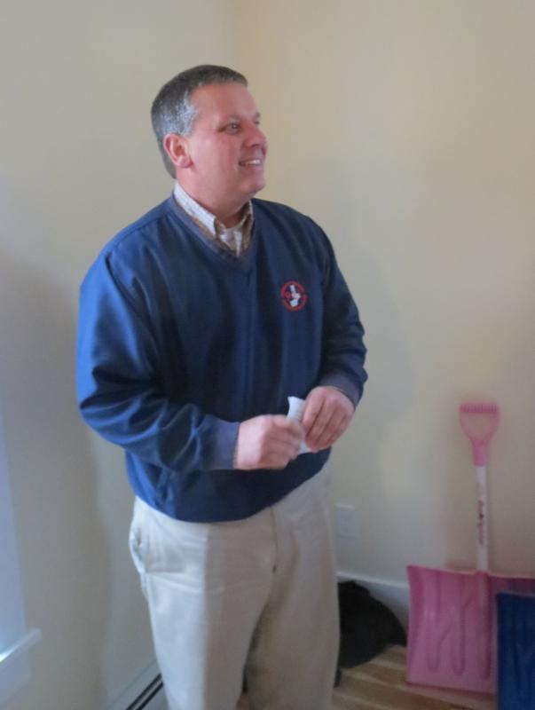 Senator Mike Thibodeau congratulates the family on their new home. (photo by Erica Thoms)