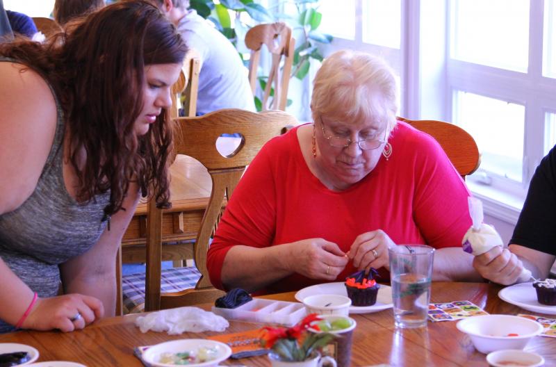 Daphne Larrabee, left, with Shirley Reynolds work on their cupcakes. (Photo Courtesy Of Charles Hamm)