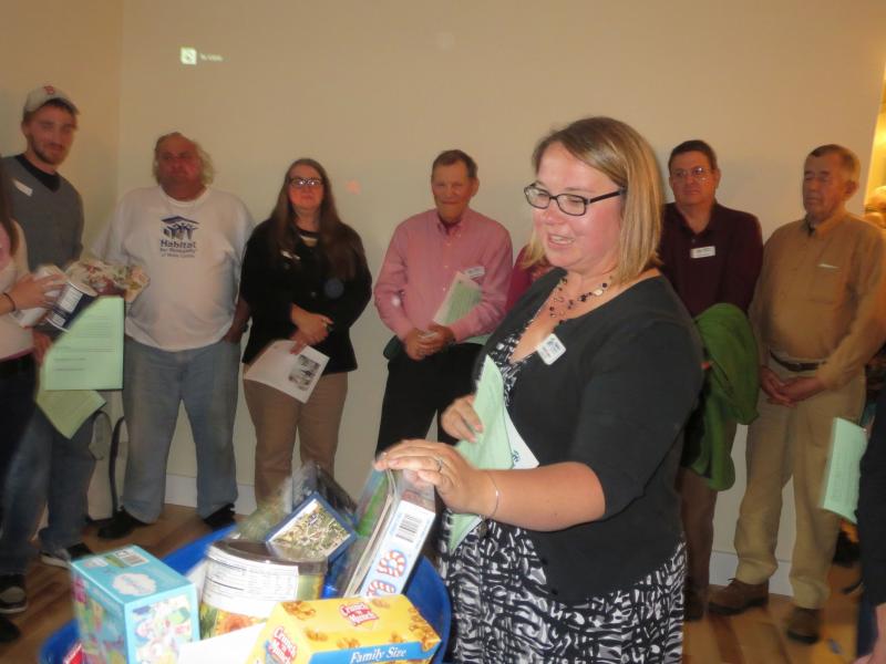 Mandie Sawyer, Executive Director of Habitat for Humanity of Waldo County, speaks to attendees before presenting the family with a gift basket. (photo by Erica Thoms)