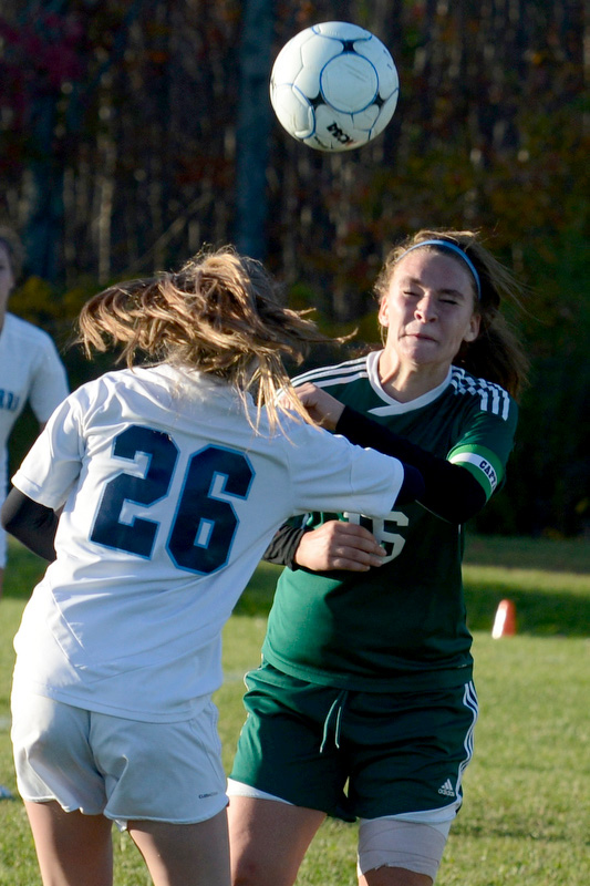 Oceanside’s Gabby Straka, (26), heads the ball before Mount View’s Ryleigh Lord could get to it. (Photo by Ron Hawkes)