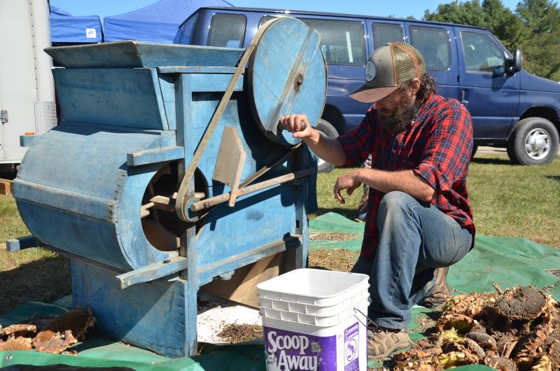 Andrew culls the husk from the buckwheat. (Photo by Lynda Clancy)
