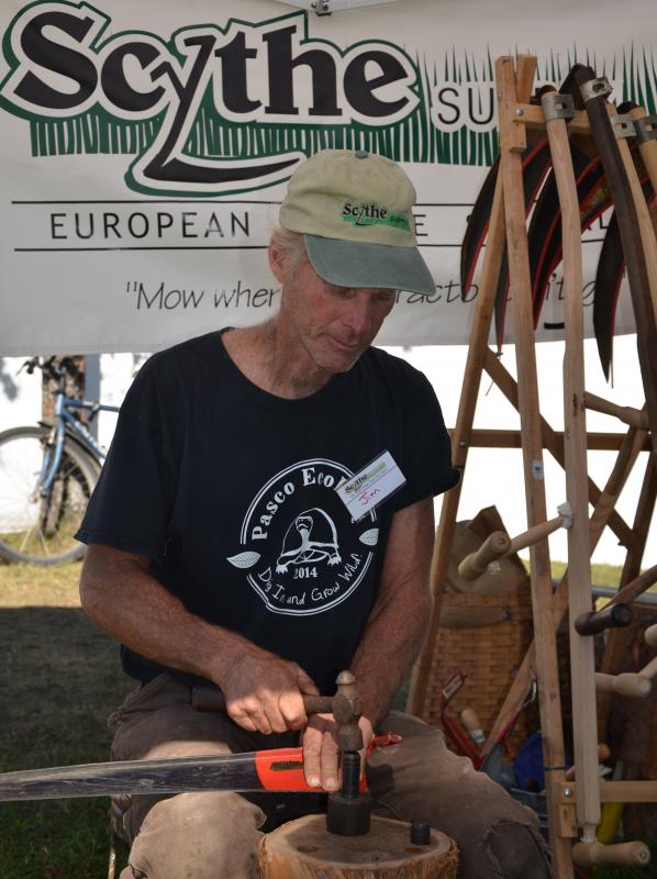 Sharpening the scythe. (Photo by Lynda Clancy)