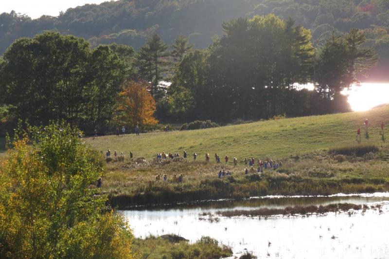Last week’s middle school cross country championships were held at the beautiful Damariscotta River Preserve. Here the girls’ team is seen running halfway through the course, the fall sun shining low.
Photo by Becky Johnson cross country