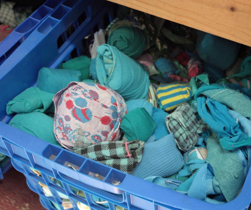 Diane and Wally O’Brien organize balls of fabric strips by color so that when fancy strikes, or a customer requests, similar colors are together and ready to weave.