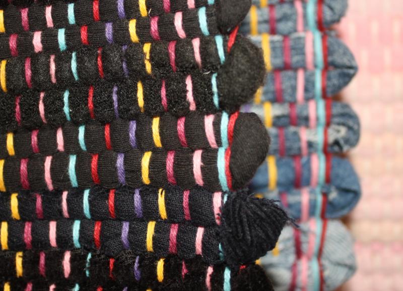 Details of a rag rug with multi-color warp.