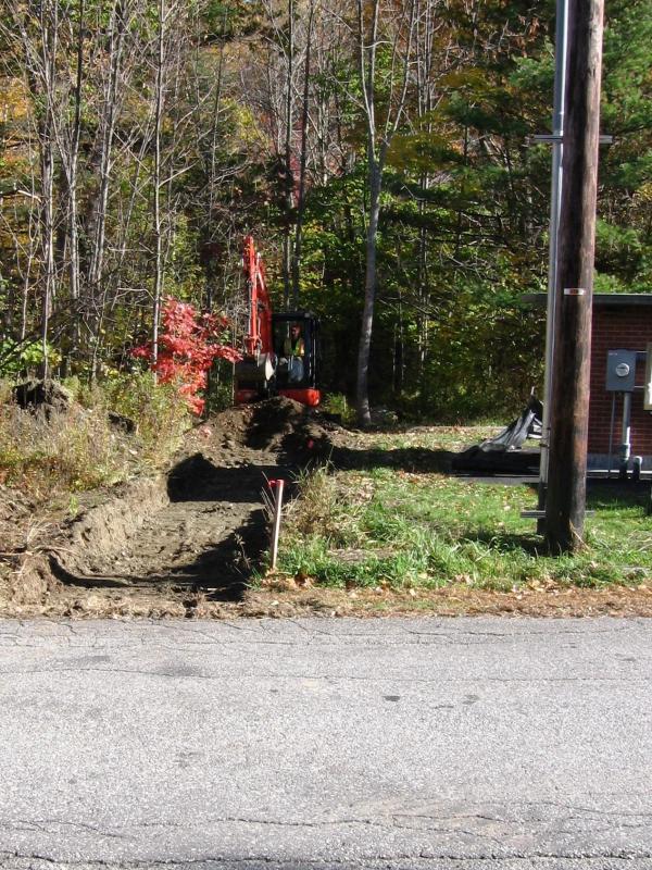 Brendan begins excavation on the trail. (Photo Courtesy of Karen Brace)