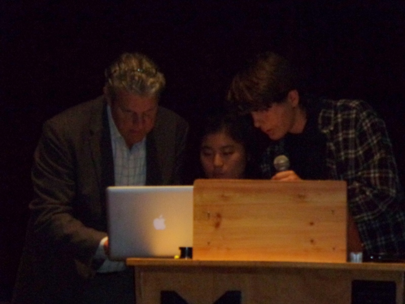 Medomak Valley High School teacher Nick Lapham helps Hindley Wang and Anton Kalmysh set up their presentation “Arts in Education.” (Photo by Sarah Thompson)