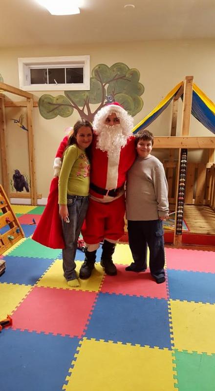 Ivy Ladd & Thane Waddell hanging out with Santa.