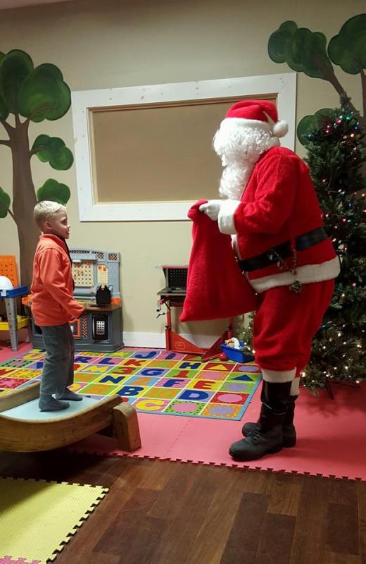 Aiden Jandreau gets a present from Santa.