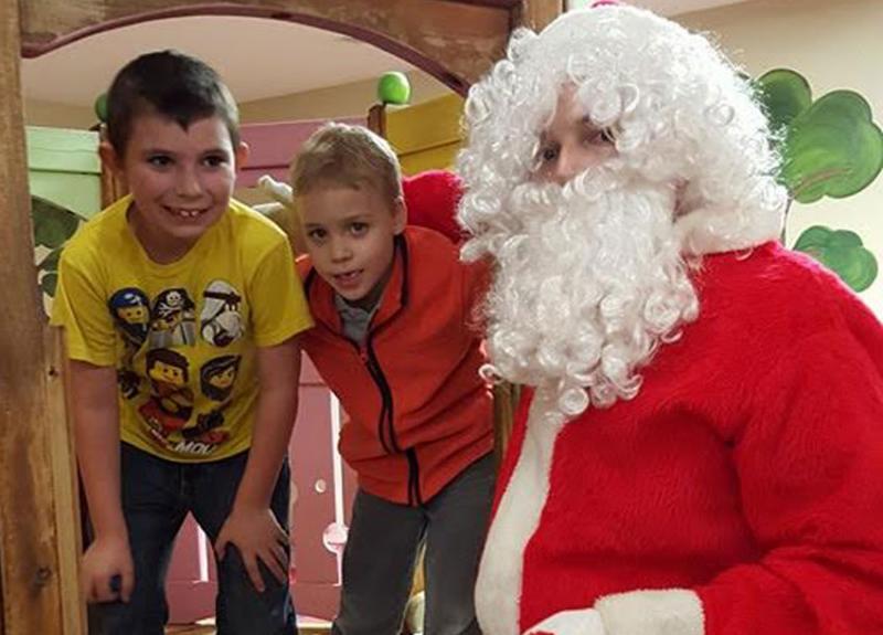 Tegan Carlson & Aiden Jandreau playing with Santa.