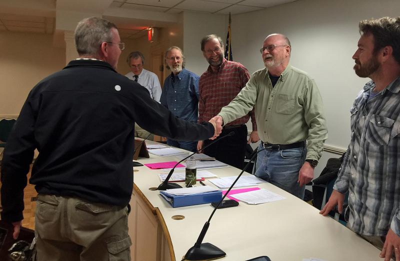 Rockport Police Sgt. Travis Ford accepts congratulations from the Select Board Tuesday night after he learned he had been named 2015 Officer of the Year. (Photo by Holly S. Edwards)