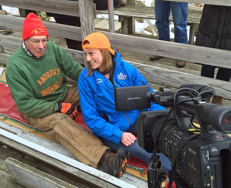Toboggan racer Andy Hazen waits for his cue while WLBZ 2 sports reporter Jessica Gagne works both sides of the video camera. (Photo by Holly S. Edwards)