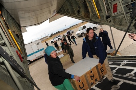 New England Aquarium volunteers and Coast Guard crew load up a Coast Guard C-130J in Coast Guard Air Station Cape Cod, Mass., with endangered sea turtles bound for recovery facilities in Orlando, Fla., Dec. 7, 2012. A record number of turtle 'cold strandings' in the Northeast coast prompted the emergency flight. The Coast Guard works with federal and state partners in times of need such as when animals are stranded or entangled. This joint effort involved close coordination with the following organizations and agencies: NOAA Fisheries Northeast Region Stranding Network, Florida Fish and Wildlife Conservation Commission, New England Aquarium, Sea World Orlando, Mote Marine Lab, Volusia Marine Science Center, Loggerhead Marinelife Center, and the Florida Aquarium. U.S. Coast Guard photo by Senior Chief Petty Officer Sarah B. Foster