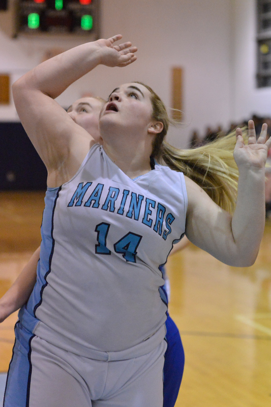 Oceanside’s Kalyn Grover puts up a shot under the basket. (Photo by Ron Hawkes)