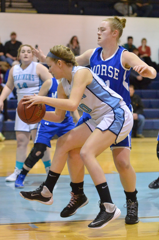 Oceanside’s Haley Montgomery puts a move on a Morse defender as she goes for the shot. (Photo by Ron Hawkes)