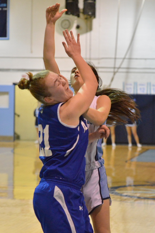 Oceanside’s Gabby Simmons went hard to the basket for to plus one as she draws the foul on the shot. (Photo by Ron Hawkes)