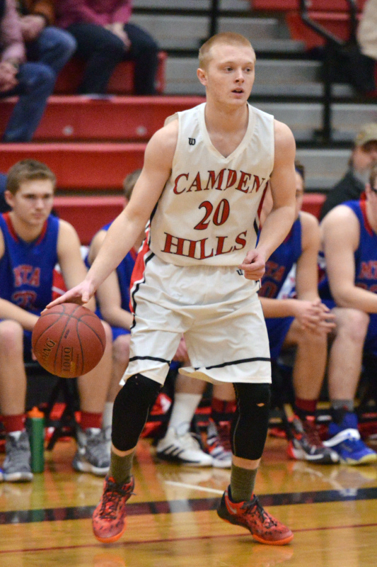 Camden Hills Gage Corson looks to drive or pass. (Photo by Ron Hawkes)