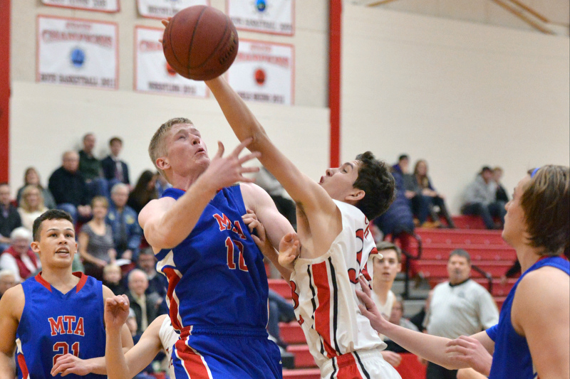 Camden’s Morgan Ford gets a hand on the ball in front of Mt. Ararat’s Garrett Bolduc. (Photo by Ron Hawkes)