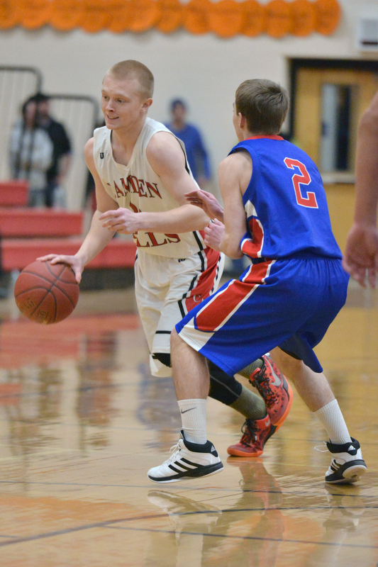 Camden’s Gage Corson, left, drives past Mt. Ararat’s Cole Guerin on his way to the basket. (Photo by Ron Hawkes)