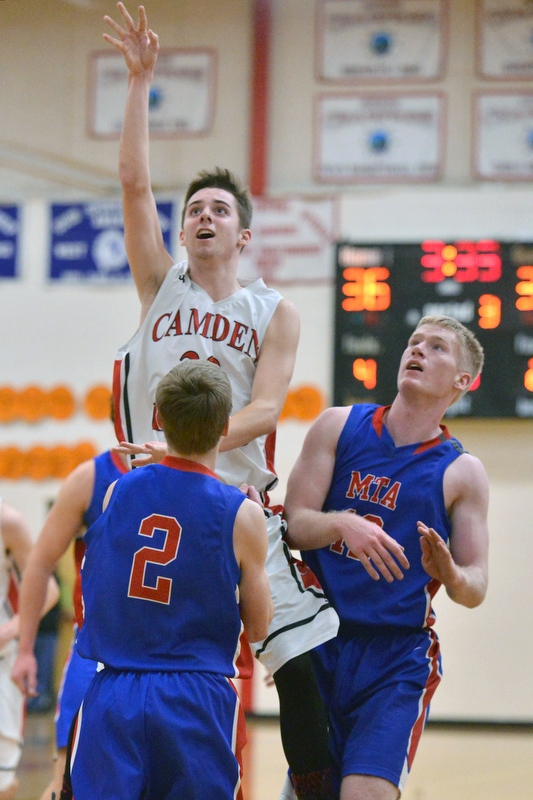 Camden’s Dalton Oakes goes up high over Mt. Ararat’s Cole Guerin as Garrett Bolduc looks on. (Photo by Ron Hawkes)