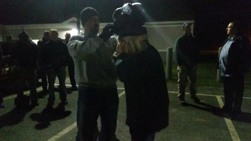 Sgt. Lance Mitchell assists a student with using protective head gear. (Photo by Sarah Shepherd)
