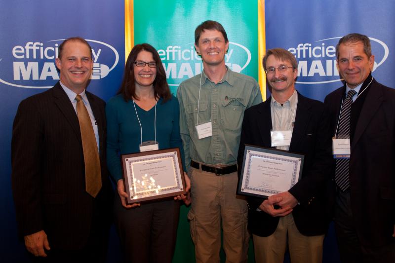 Michael Stoddard, left, Executive Director of Efficiency Maine, honored Evergreen Home Performance’s outstanding contributions to energy efficiency through leadership in marketing and residential programs. Accepting the awards are Kathleen Meil, Marketing Manager; Richard Burbank, President; and Brian Robinson, Energy Advisor. Evergreen Home Performance | Efficiency Maine Awards | Energy Efficiency Audits & Insulation | Maine
