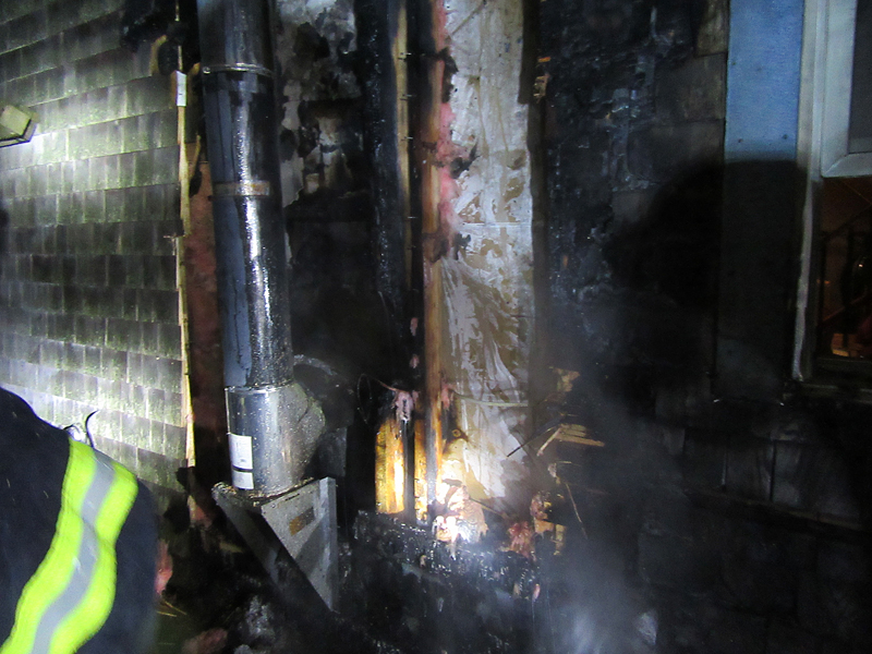In lieu of a double-metal jacket or other kind of heat shield, aluminum foil was used to try and protect the wood wall from the heat emanating from the pipe stove during use. But the foil, also a metal, actually acted as a heat conductor and helped ignite the wood wall. (Courtesy Rockport Fire Department)