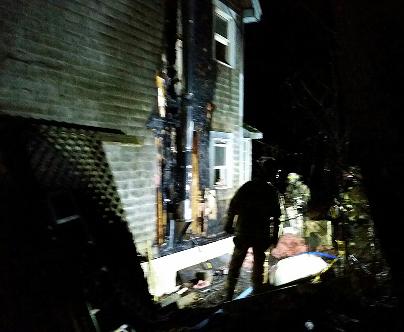 Firefighters survey the damage on Winding Way in Rockport Saturday night. (Photo by Sarah Shepherd)