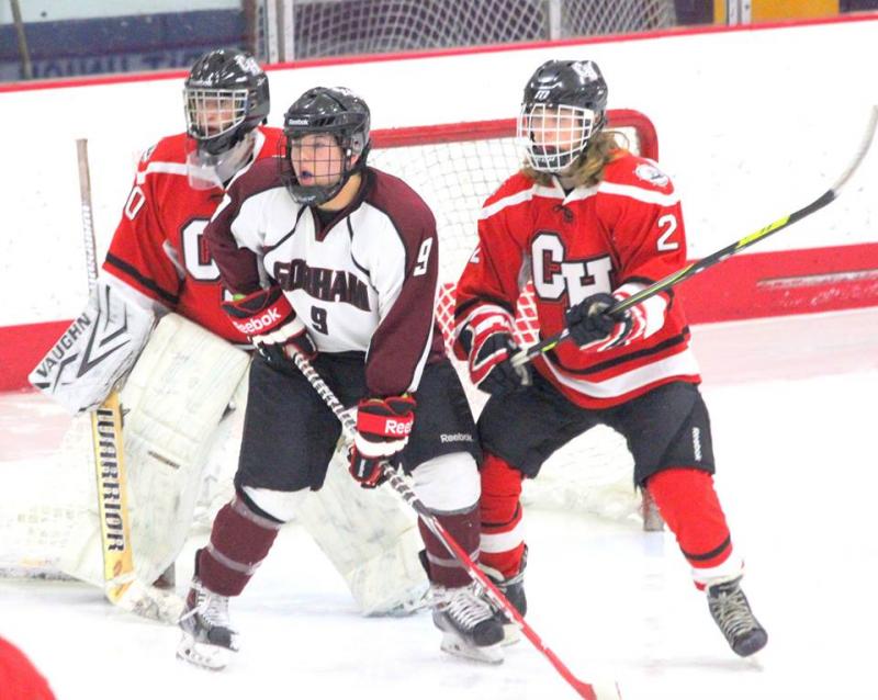 Windjammer Defenseman Dan Lydon (#21) defends Gorham forward Holden Edwards (#9) at the Camden Hills net front as goalie Zach Hand (#30) looks on. (Photo Courtesy of Molly Cole)