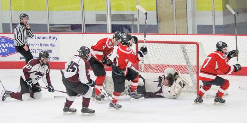 Camden Hills Kieran Lydon (#17) scores from the back door right post as Gorham goalie attempts to slide across to make a desperate save losing his goalie mask in the process. Linemates Chase Matteo (#4) and a player (#5) look on. (Photo Courtesy of Molly Cole)