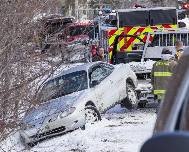 Steve Laite of Camden Exxon removes the vehicle from a ditch on Park Street. (Photo courtesy Isaac Remsen)