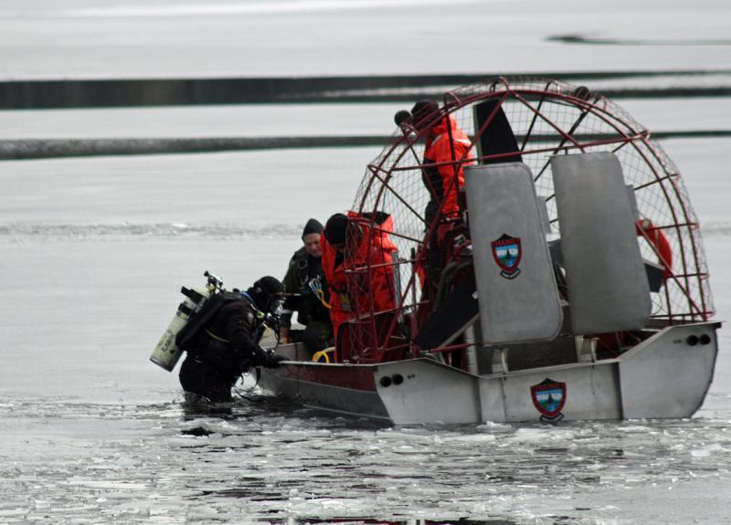 A diver slips into the lake Tuesday morning. (Photo by Holly S. Edwards)