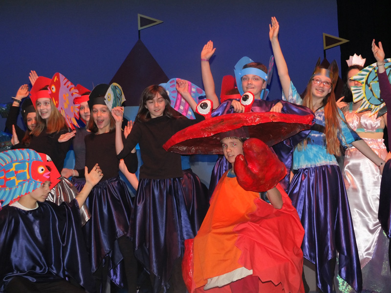 Cast members pose at the end of a song