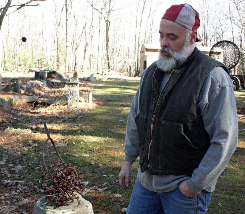 Jay Sawyer and his sculpture, Stick a Fork In It. (Photo by Holly S. Edwards)