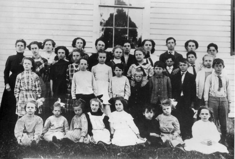 The Centre School in 1911. In the front row Marjorie Calderwood is third from the left, fifth from left is Doris Heal, and third from the left in the third row is Hester Calderwood. Teacher Sadie Knight, far left fourth row, was responsible for thirty-three pupils in the one room school; all eight grades are represented here. The school building was pulled across the road by some 150 townspeople in 201 and rebuilt as the Lincolnville Community Library. (Photo courtesy of the Lincolnville Historical Society) centre school