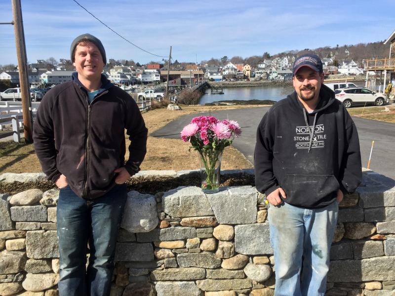 Joe Norton, left, and Willie Morton stand in front of the stone wall they built at Margaret and Steve Branch’s home, at the east end of the footbridge in Boothbay Harbor. SUZI THAYER/Boothbay Register Joe Norton and Willie Morton