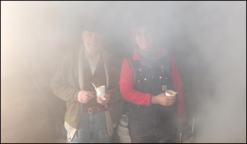 Winston Pendleton and his daughter, Wendy Harvey, are lost in steam as they make maple syrup at the Conway House Museum’s sugarshack Sunday. (Photo by Chris Wolf)