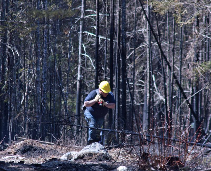 Sometimes, hoses can be brought short distances into woods fires, but it’s hard work lugging them in, and then out again. (Photo by Holly S. Edwards)
