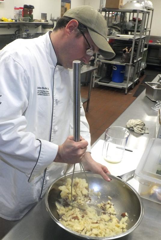 Charles Butler mashes potatoes to top the Shepherd’s Pie