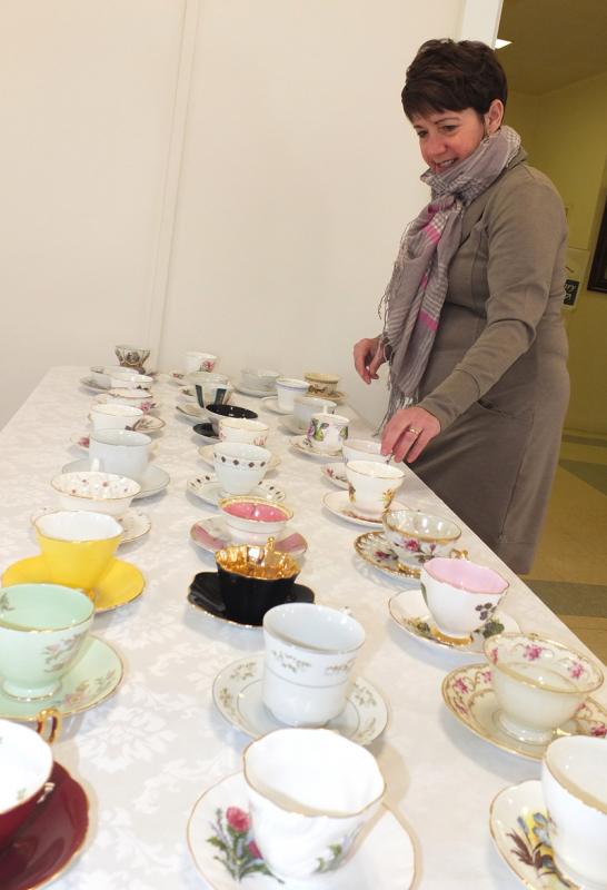 Leslie Fillnow makes sure the elegant teacups are perfect.
