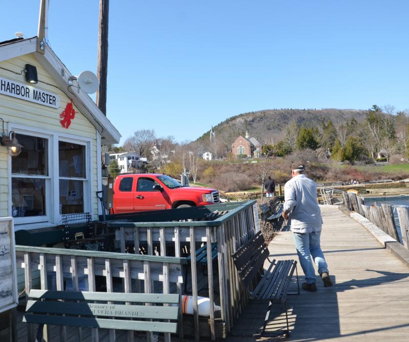 The fencing around the Camden Harbor Master’s building is like Pippi Longstocking’s house, all askew, after the April 11 storm. (Photo by Lynda Clancy)