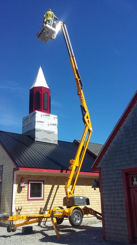 From the ground to the top of the building, a new steeple gets set into place.